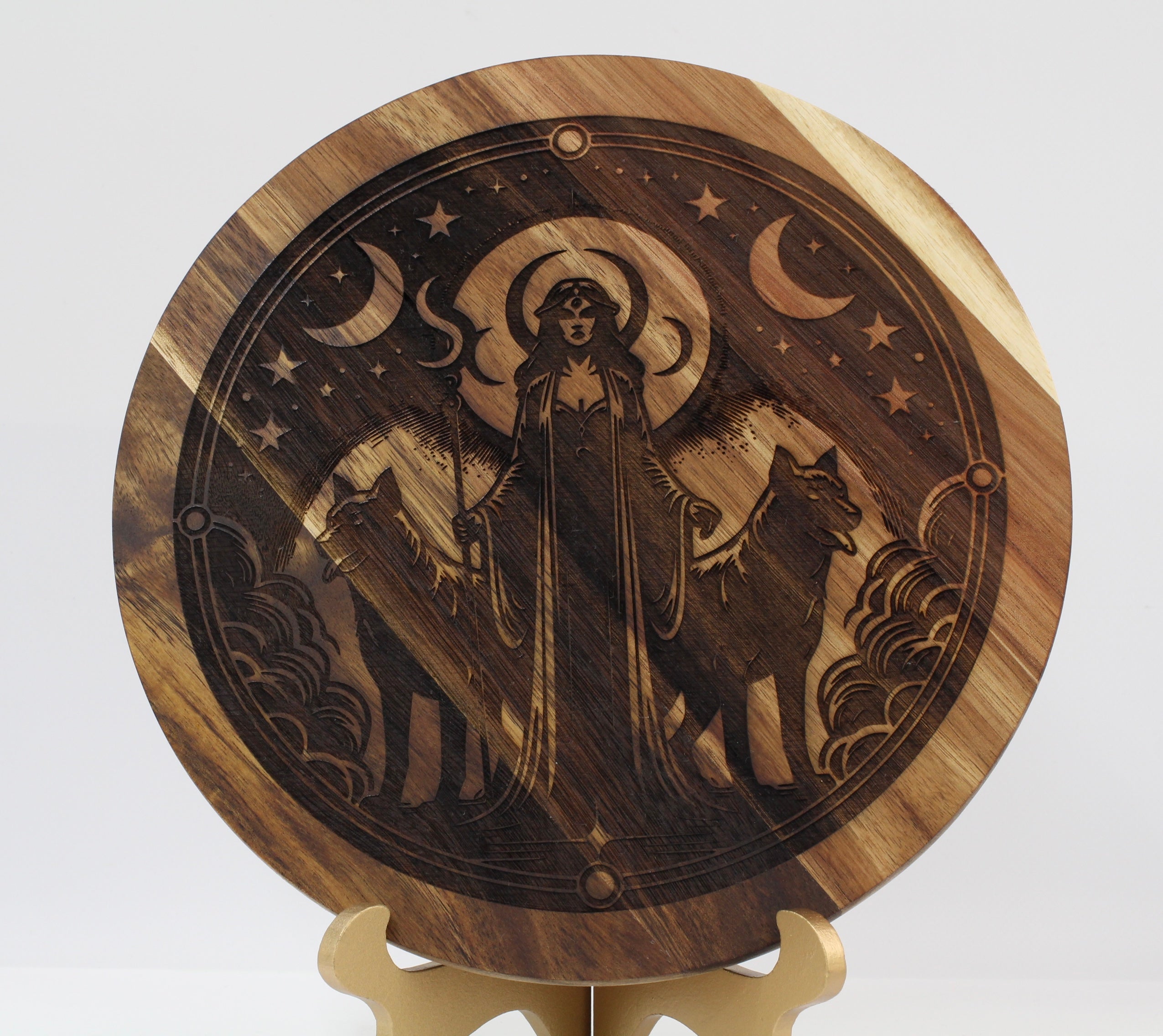 Wooden disc with engraved design of Hecate and animals on a stand